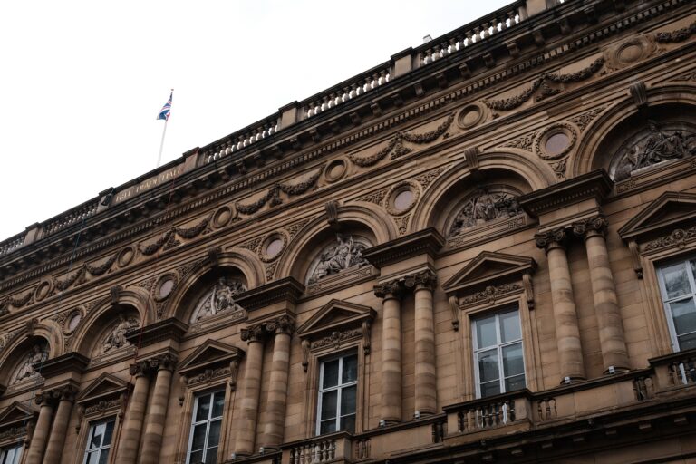 A detailed view of the historic Free Trade Hall's architectural facade in Manchester, UK.